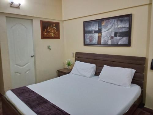 a bedroom with a white bed and a white door at Furnished One Bed Room Apartment Ground Floor With Kitchen in Karachi
