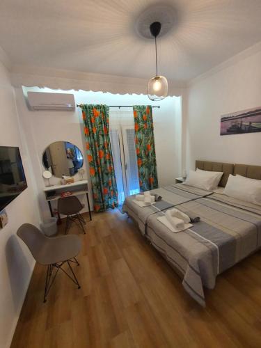 a bedroom with two beds and a table and a mirror at Villa Fer Forze you have the feeling of your own holiday home in Asprovalta