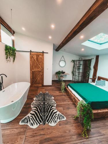 a bathroom with a zebra rug on the floor and a tub at Utopia by NorAtlas Heritage - Adults Only in Buzau