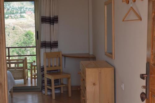 a room with a desk and a chair and a window at Sora Lodge Lalibela in Lalībela