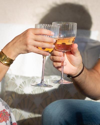 two people holding wine glasses in their hands at Mas Coeur Provence Calme Beauté Grand Parc in Pernes-les-Fontaines
