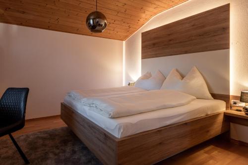 a bedroom with a large bed with a wooden headboard at Gschwendtners Apartment in Werfenweng