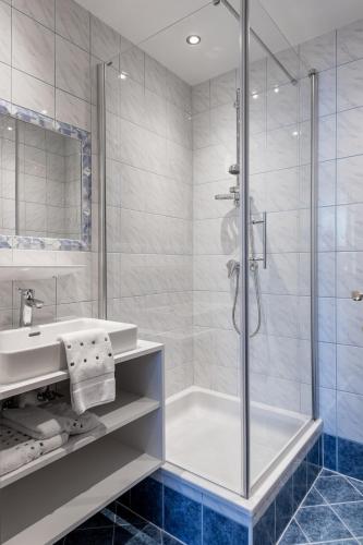 a bathroom with a shower and a sink at Gschwendtners Apartment in Werfenweng