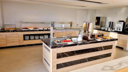 a kitchen with a counter with food on it at Sunny Bay Hotel in Kissamos