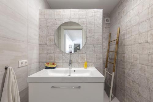 a bathroom with a white sink and a mirror at Casa La Puente in Mijas