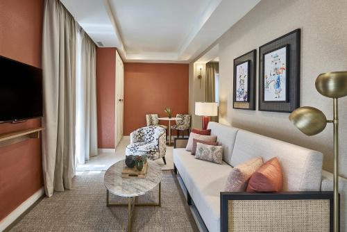 a living room with a couch and a table at Vincci Molviedro Suites Apartments in Seville