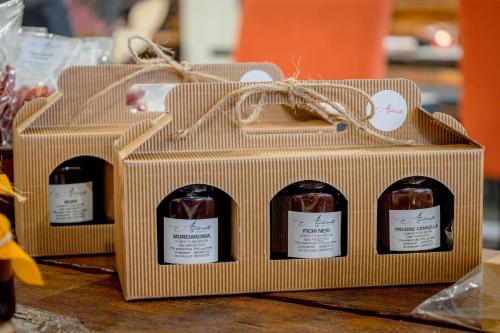 three boxes of wine sitting on a table at Arbulé Agriturismo & Spa Valtellina in Poggiridenti