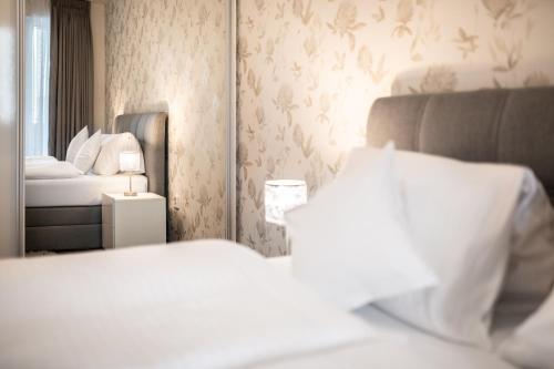 a hotel room with a bed and a mirror at Apartmány Horská, Vrchlabí in Vrchlabí