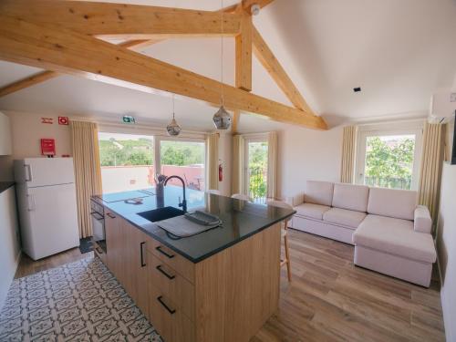 a kitchen with a large island in a room at Quinta Vale de Sousa - Douro Valley in Peso da Régua