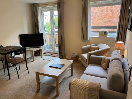 a living room with a couch and a table at Number 10 Serviced Apartment - Chapel in Southampton