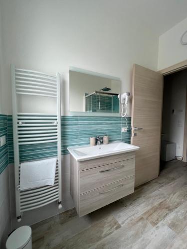a bathroom with a white sink and a mirror at Maison Merci in Pedemonte