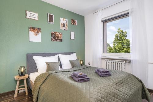 um quarto com uma cama com uma parede verde em FREE LIVING - VW näher geht nicht, Parkplatz, Küche, Wlan em Wolfsburg