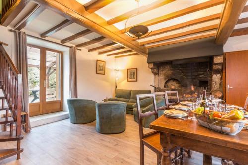 a living room with a table and a fireplace at Fleurey la Cabotaine in Mont-Saint-Jean