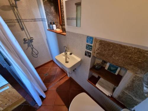 a small bathroom with a sink and a shower at Torre Tanquián Eco Finca - Ribeira Sacra in Pantón