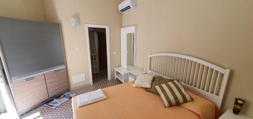 a small bedroom with a bed and a window at La Capasa di CasAda in Spongano