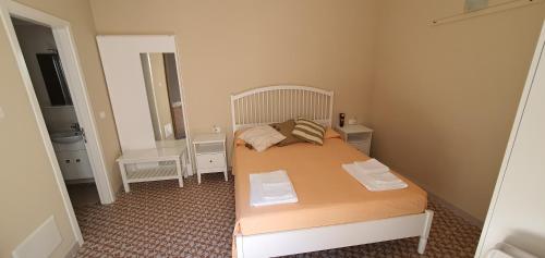 a small bedroom with a bed and a bathroom at La Capasa di CasAda in Spongano