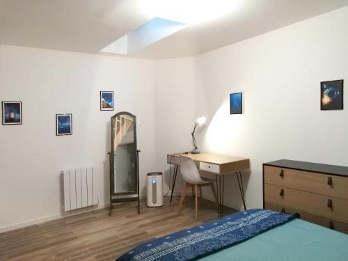 a bedroom with a bed and a desk and a mirror at Blue Rent in Bron