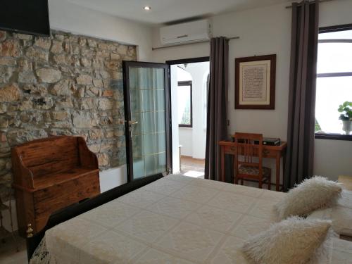 - une chambre avec un grand lit et un mur en pierre dans l'établissement Ca' Pietra di Nonno Pietro, à Gavardo