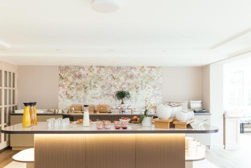 a kitchen with a large painting of flowers on the wall at la couronne Hotel & Spa in Zermatt