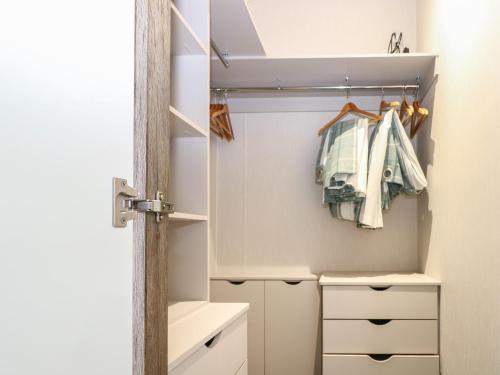 a small bathroom with a closet with white cabinets at Lodge at Chichester Lakeside 2 Bed in Chichester