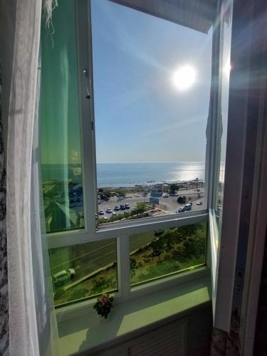 a window with a view of a parking lot at У моря in Aktau