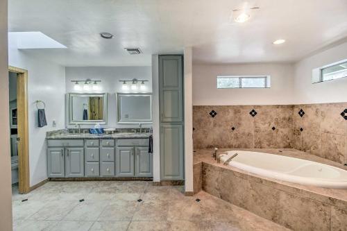 a large bathroom with a tub and a sink at Cozy Pinetop Retreat with Yard and Heated Gazebo! in Indian Pine