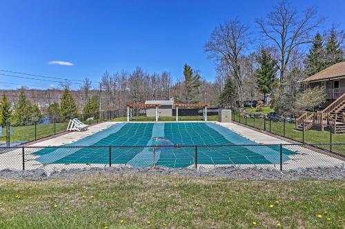 a swimming pool with a fence around it at Poconos Cabin Serene Deck, Fire Pit and Game Room in Tobyhanna