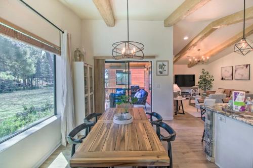a wooden table and chairs in a room with a window at Game Room and Private Dock Lakeside Cabin! in Lake of the Woods