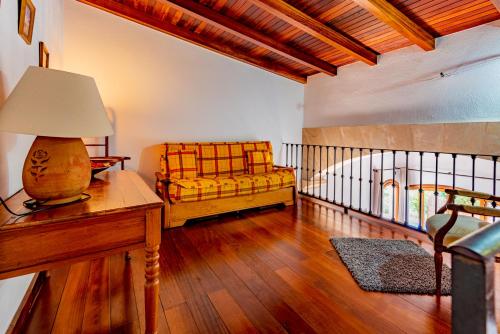 a living room with a couch and a lamp on a table at Villa in center of Pollensa with pool and jacuzzi in Pollença