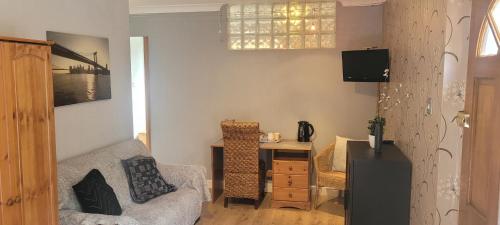 a living room with a couch and a table at Eskdale in Woolton