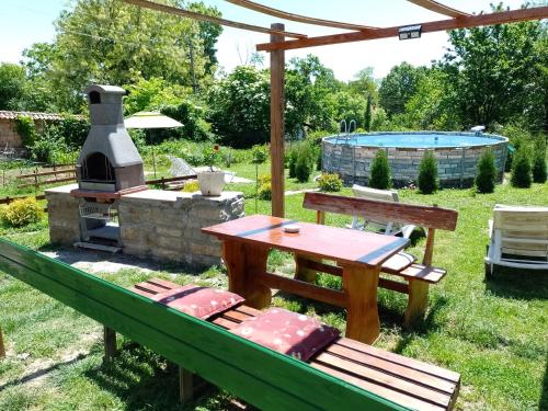 un patio trasero con una mesa de picnic y una parrilla en Вила Нина в Крамолин en Kramolin
