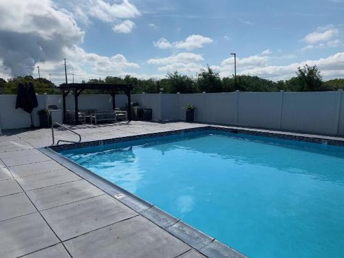 a large blue swimming pool in a backyard at Comfort Inn & Suites Pottstown Eastern Gateway in Pottstown