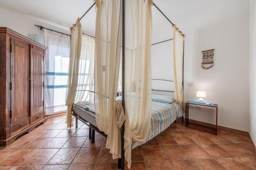 A bed or beds in a room at Trivano Panoramico Villasimius