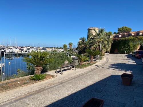 a street with a bench next to a marina at limoneto in Trabia