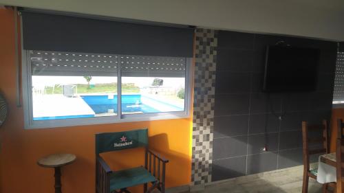 a bathroom with a view of a swimming pool through a window at Mar del Plata Sur 2 in Mar del Plata