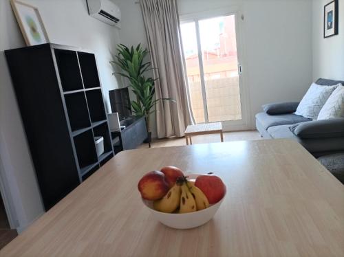 a bowl of fruit on a table in a living room at COOL! 5' to metro. 15' to Center/beach by metro. in Santa Coloma de Gramanet