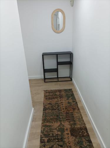 a hallway with a table and a rug at COOL! 5' to metro. 15' to Center/beach by metro. in Santa Coloma de Gramanet