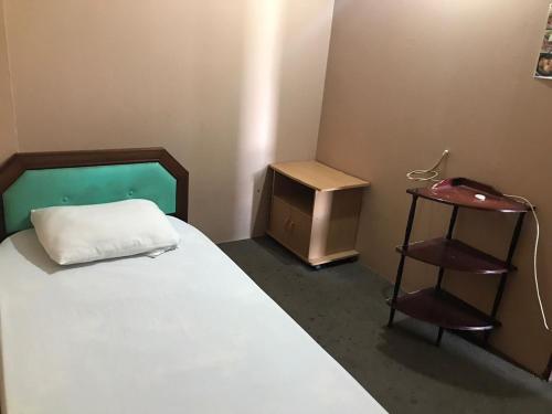 a small room with a bed and a small table at MOTEL TERMINAL INN in Inanam