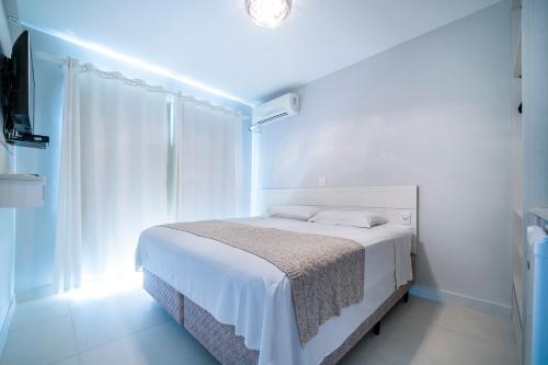 Giường trong phòng chung tại Residencial Bombinhas