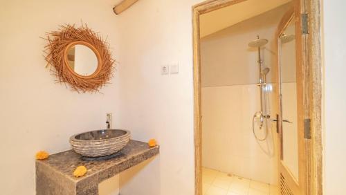 a bathroom with a sink and a mirror at Aura Dormitory House Ubud in Ubud