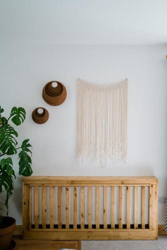 a wooden bench in a room with a window at Modern self catering apartment, Miltown Malbay in Miltown Malbay