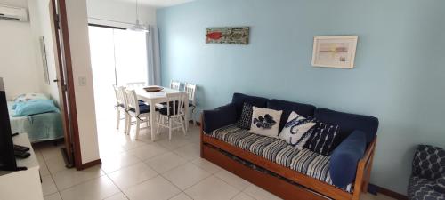 a living room with a couch and a table at Cantinho da Praia in Arraial do Cabo