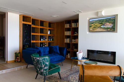 B&B & SPA Novantadieci Club في أدري: غرفة معيشة مع أريكة زرقاء وتلفزيون