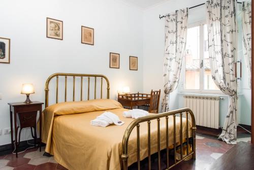 a bedroom with a bed with towels on it at Holidays Banchi Vecchi Apartment in Rome