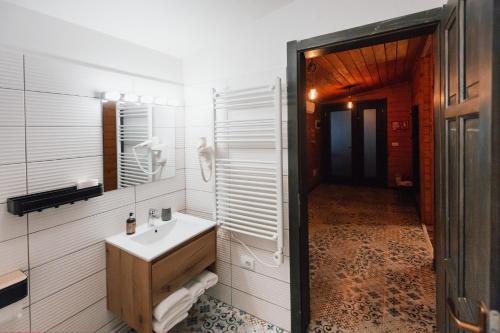 a bathroom with a sink and a mirror at Shurra in Buzău