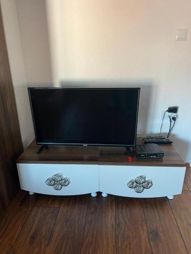 a flat screen tv sitting on top of a white cabinet at Villa Abi Center in Struga