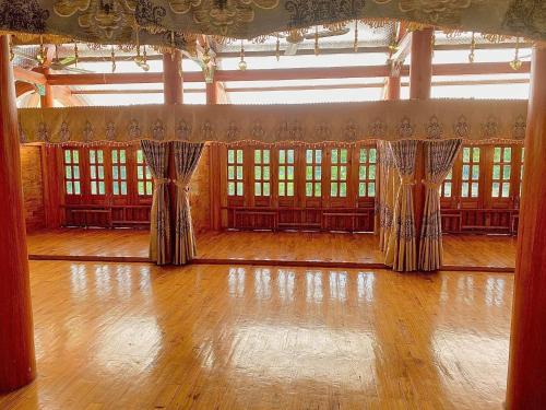 a ballroom with curtains and a wooden floor at Xuân nghi homestay in Yen Bai