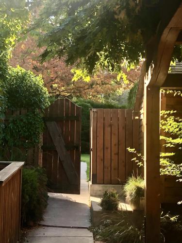 an entrance to a wooden fence with a gate at Mistiso's Place Vacation Rentals in Nelson
