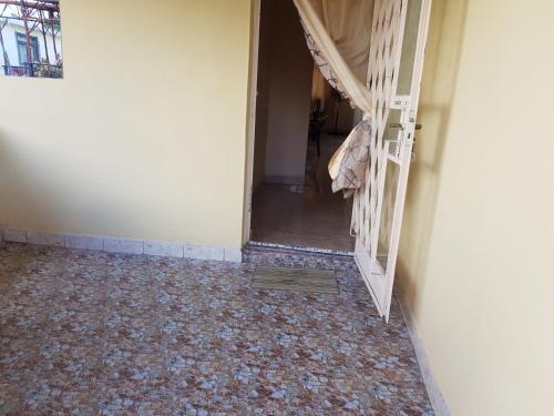 an empty room with a hallway with a door and a floor at Adorable 2bedroom homestay in Beau Bassin