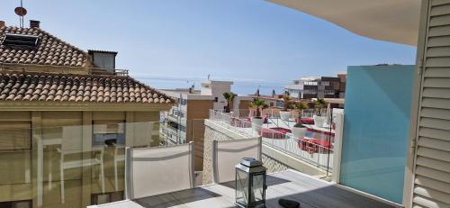 an apartment balcony with a view of the ocean at Bonito apartamento Carvajal - Fuengirola - The Wave in Fuengirola